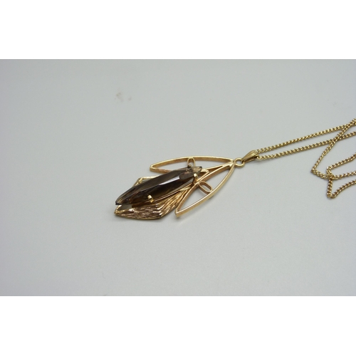 962 - A 1960's 9ct gold and smoky quartz pendant and chain, 8.4g