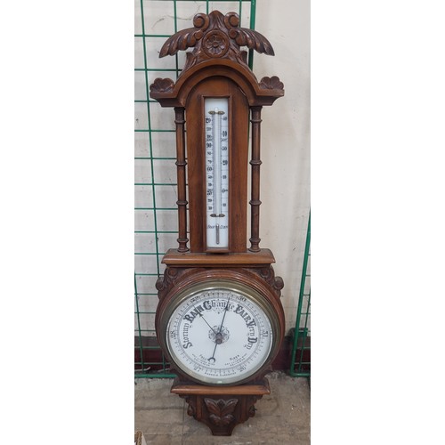 322A - An Edward VII carved walnut aneroid barometer