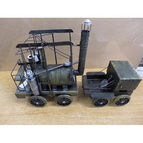 2142 - A tin plate model steam locomotive with trailer