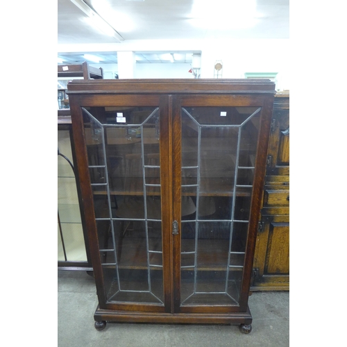 106 - An early 20th Century oak and leaded glass two door bookcase