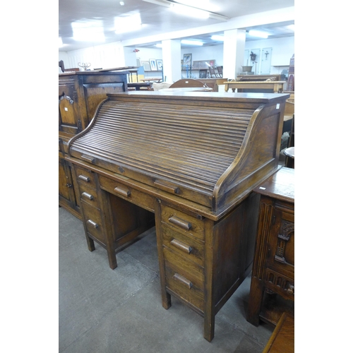 108 - An early 20th Century oak tambour roll top desk