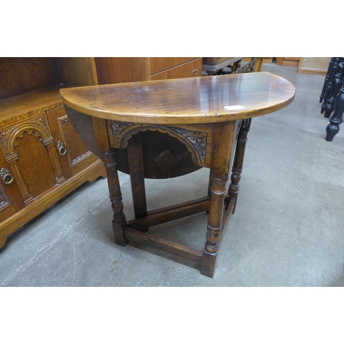 109 - A 17th Century style Ipswich oak demi-lune drop-leaf occasional table