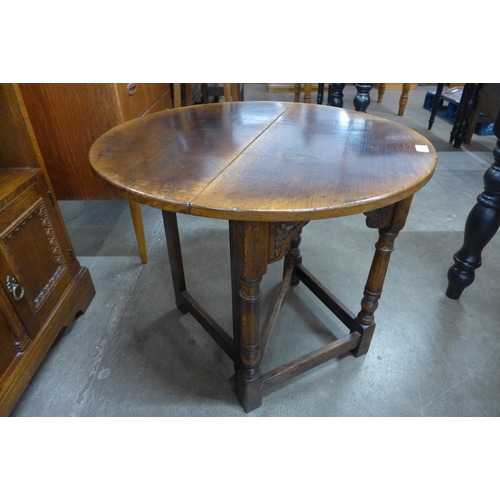 109 - A 17th Century style Ipswich oak demi-lune drop-leaf occasional table