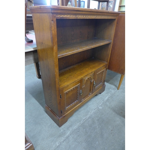 113 - A carved oak open bookcase