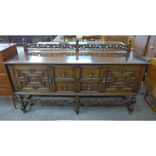 114 - An early 20th Century Jacobean Revival carved oak sideboard