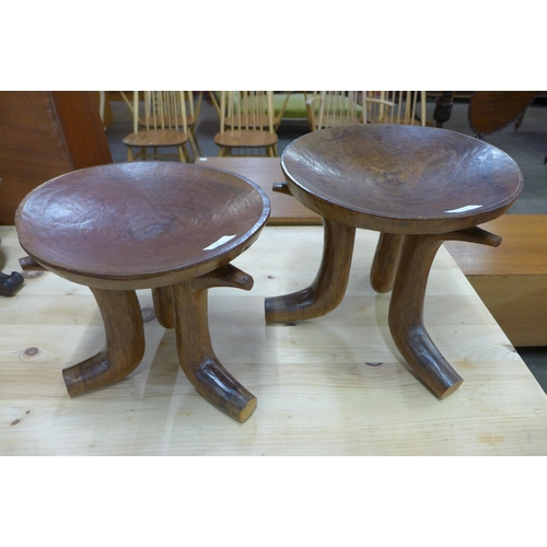 120 - A pair of African carved softwood stools