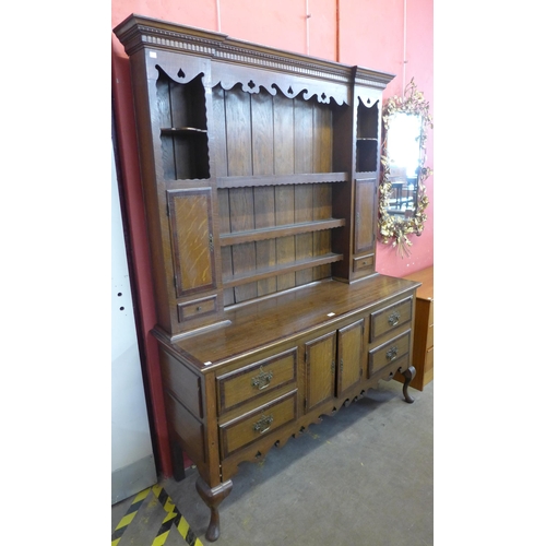 128 - A George II style inlaid oak dresser