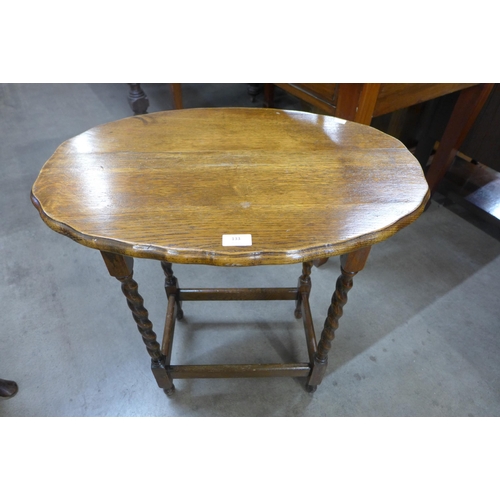 133 - An oak barleytwist oval occasional table