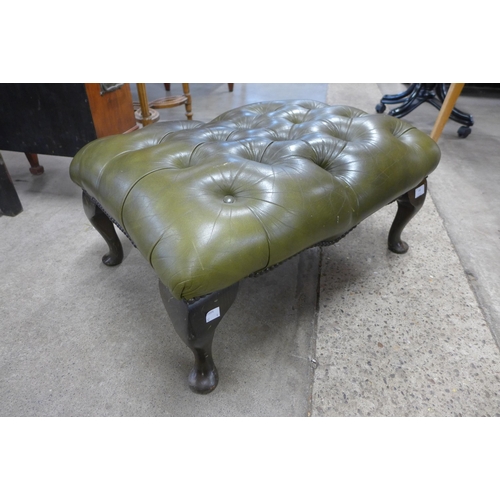 140 - A green leather Chesterfield footstool