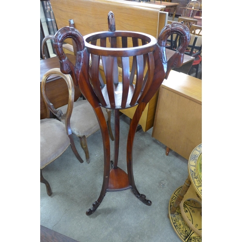 143 - An Italian style mahogany swan head jardiniere on stand