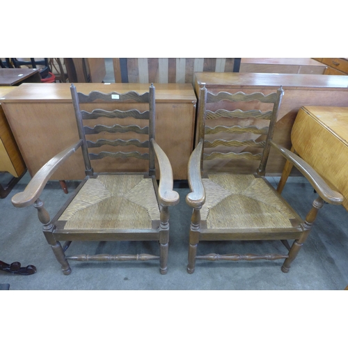 145 - A pair of French oak and rush seated fireside chairs