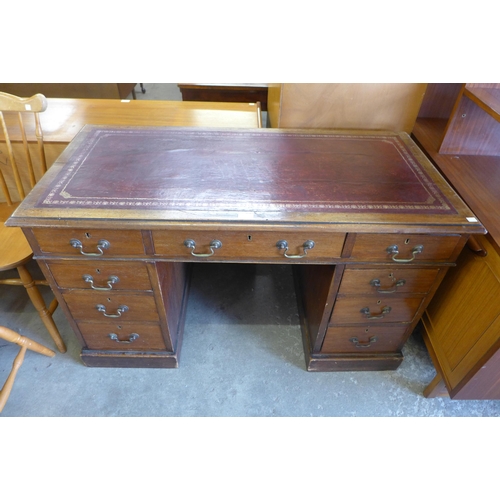 155 - A Victorian mahogany and red leather topped pedestal desk