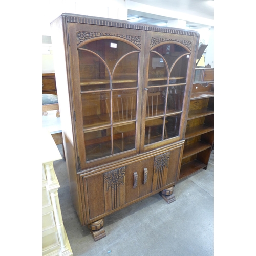 157 - An early 20th Century carved oak two door bookcase