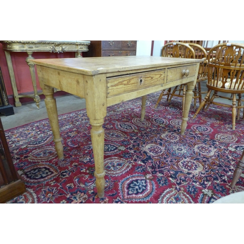 17 - A Victorian waxed pine two drawer kitchen table