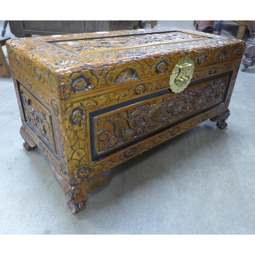 173 - A small oriental carved camphorwood blanket box