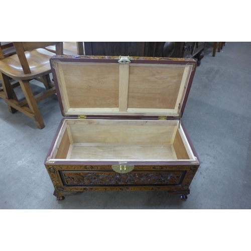 173 - A small oriental carved camphorwood blanket box