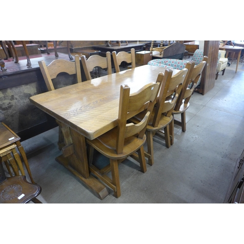 176 - A Cotswolds style oak refectory table and six chairs