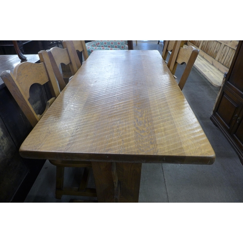 176 - A Cotswolds style oak refectory table and six chairs