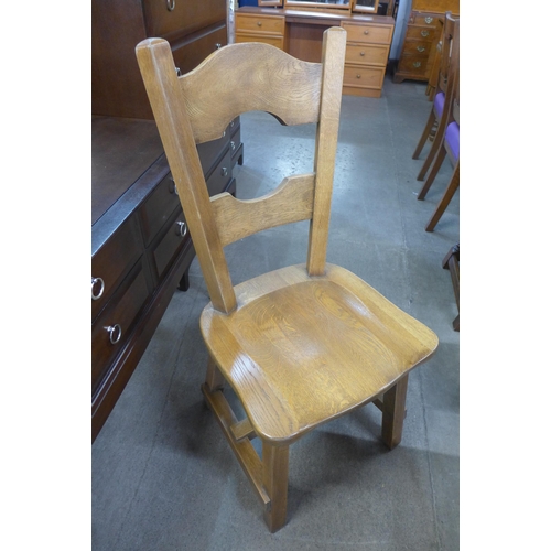 176 - A Cotswolds style oak refectory table and six chairs