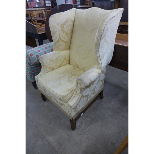 182 - An early 20th Century Queen Anne style mahogany and fabric upholstered wingback armchair