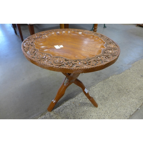 183 - An African carved wood folding occasional table