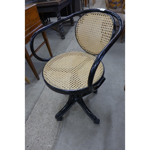 185 - A Thonet style ebonised bentwood and rattan revolving desk chair