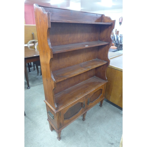 189 - An Edward VII stained pine open bookcase