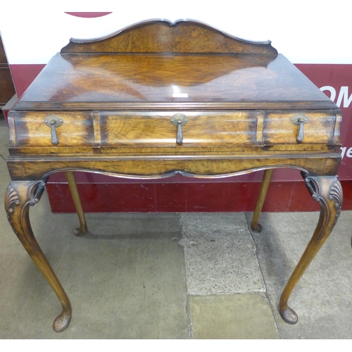 23 - A Queen Anne style figured walnut three drawer lady's writing table