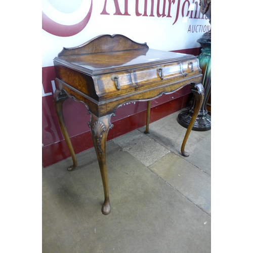 23 - A Queen Anne style figured walnut three drawer lady's writing table