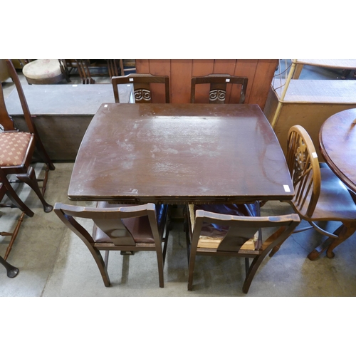 231 - An oak draw-leaf table and four chairs