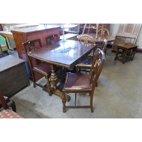 231 - An oak draw-leaf table and four chairs