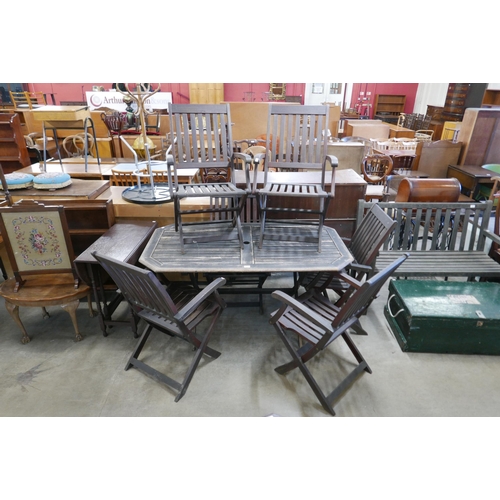 239 - A teak garden table and six folding chairs