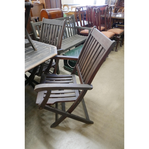 239 - A teak garden table and six folding chairs