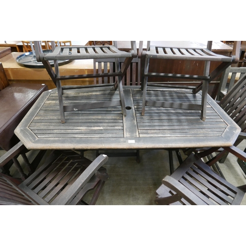 239 - A teak garden table and six folding chairs