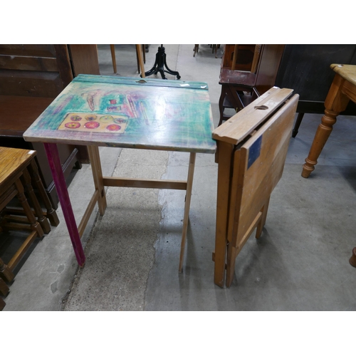 252 - A pair of child's beech folding school desks and a mahogany elephant based coffee table