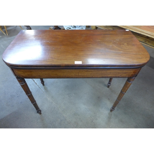 26 - A George IV mahogany D-shaped fold over games table