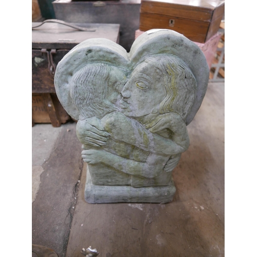 266 - A concrete garden sculpture depicting two lovers