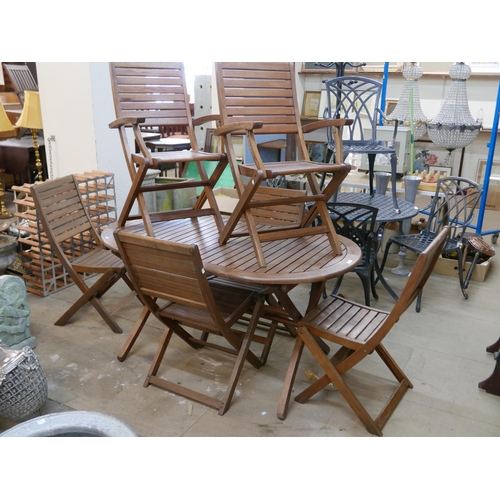 268 - A teak folding garden table and six chairs