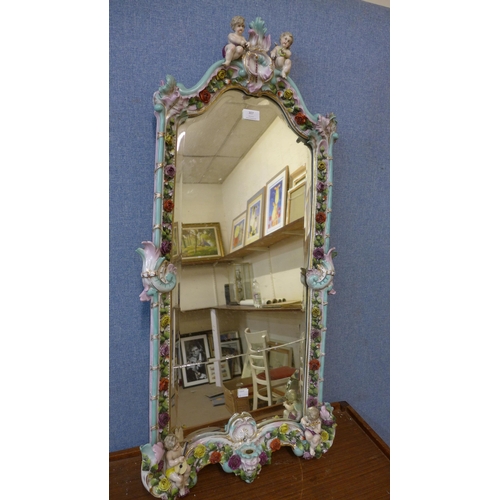 307 - A Meissen style floral encrusted porcelain framed mirror, a/f