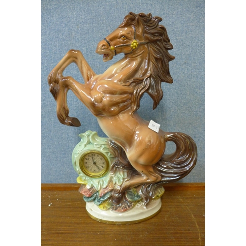 332 - A continental porcelain figural horse mantel timepiece