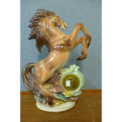 332 - A continental porcelain figural horse mantel timepiece