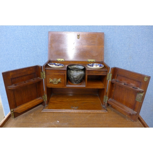 345 - An Edward VII carved oak smokers cabinet