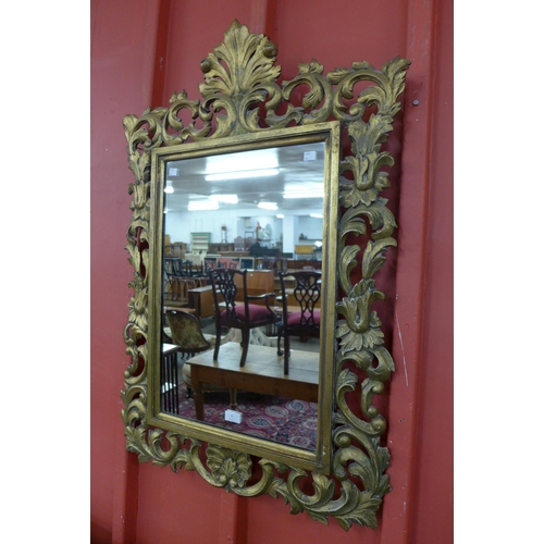 4 - A Florentine carved giltwood framed mirror