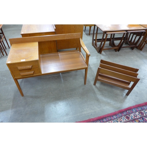 43 - A teak telephone table and a magazine rack