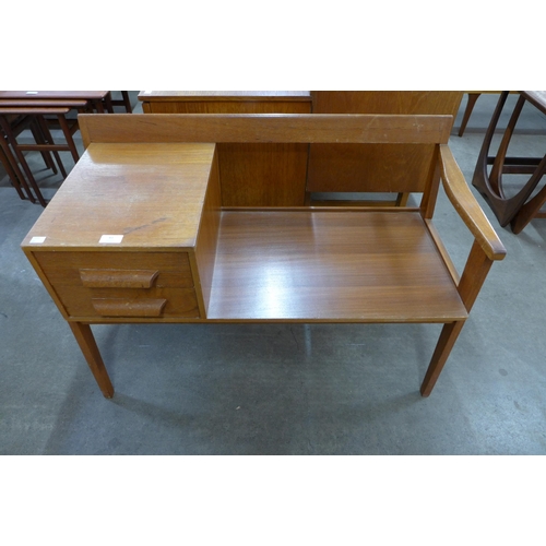 43 - A teak telephone table and a magazine rack