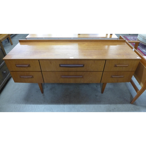 47 - A teak six drawer sideboard