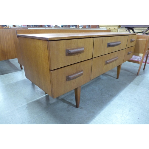 47 - A teak six drawer sideboard