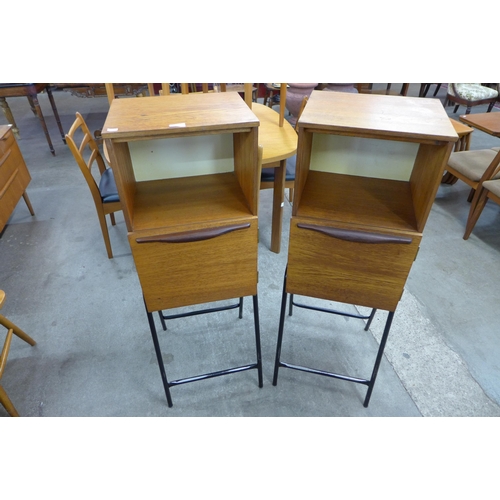 81 - A pair of teak cabinets on black metal stands