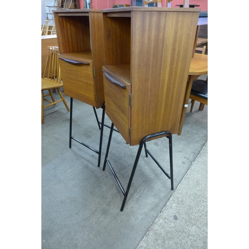 81 - A pair of teak cabinets on black metal stands