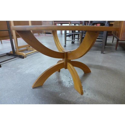 91 - A teak and glass topped circular coffee table